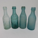 Four Hutchinson style beer bottles