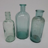 Three old medicine bottles
