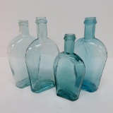 Four blue green flask bottles