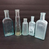 Five old medicine bottles