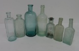 Seven early glass bottles