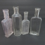 Four clear medicine bottles