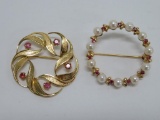 Two lovely circle pins, one marked 14 kt, ruby and pearl