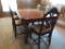 Walnut dining room table with six chairs and two leaves