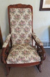 Grape and Cable carved back rocker with rose upholstered back and arms