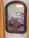 Carved wall mirror with mercury glass tie backs, 23 1/2