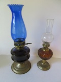 Two decorative oil lamps, colored fonts and metal bases