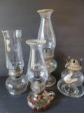 Four small oil lamps