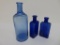 Three cobalt medicine bottles