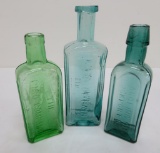 Three lovely colored medicine bottles, green and teal, 5 1/2 and 6 1/2