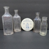 Four vintage medicine bottles and Druggist pocket mirror