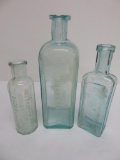 Three Aqua Liniment Bottles