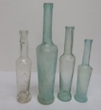 Four Cylindrical oil and liquor bottles