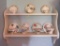 Seven cups and saucers and wooden display shelf