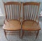 Pair of spindle back chairs with hip rests and cane seats