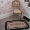 Nut carved side chair and vintage braided rug