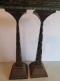 Two contemporary heavy metal candle stands, 19