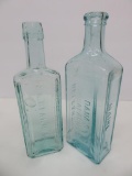 Two large aqua medicine bottles, Sarsaparilla and Peruvian Syrup