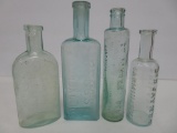 Four Oil, Essence and Balsam bottles, aqua and green, 5 1/4
