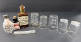 Pharmacy bottles and medicine cups with advertising Milwaukee Pharmacies