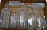 Nine assorted medicine bottles, clear, 3 1/2