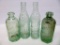 Four green Graf soda bottles