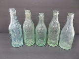 Five Milwaukee soda bottles