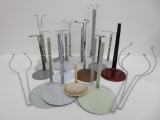 13 complete metal doll stands and six extra stands and arms