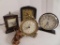 Four vintage clocks, one with barometer/thermometer