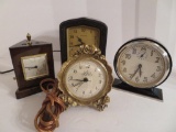 Four vintage clocks, one with barometer/thermometer