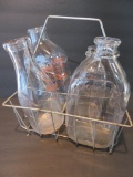 Four milk bottles in carrier