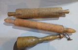 Two early one piece wooden rolling pins and wooden masher