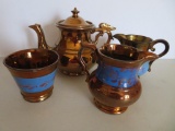 Ornate copper luster dragon tea pot and blue banded creamers