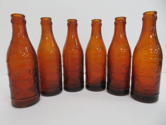 Six Amber Gay-Ola bottles