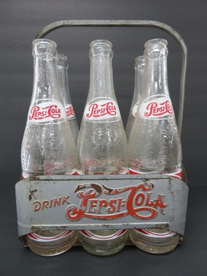 Six Pepsi Cola single dot bottles in metal carrier
