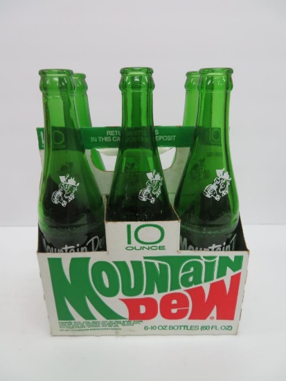 Six 10 oz Filled by Mountain Dew bottles in cardboard carrier