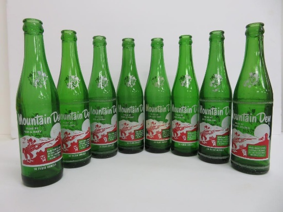 Seven vintage Mountain Dew Bottles, Filled By
