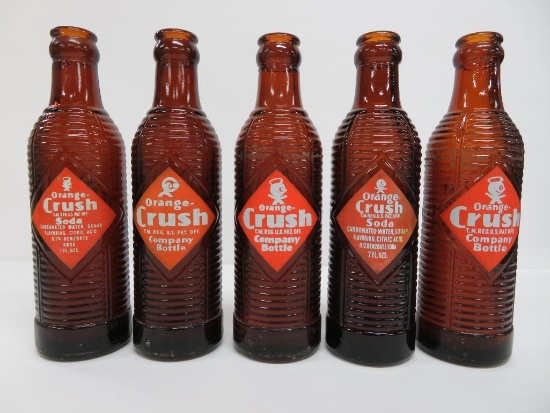 Six Amber Orange Crush bottles, 7 3/4"