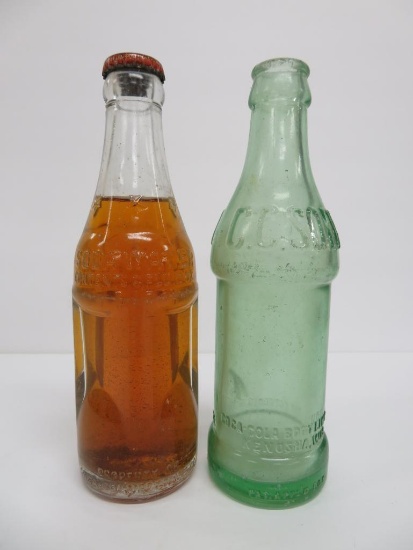 Clear and green Coca Cola Bottles