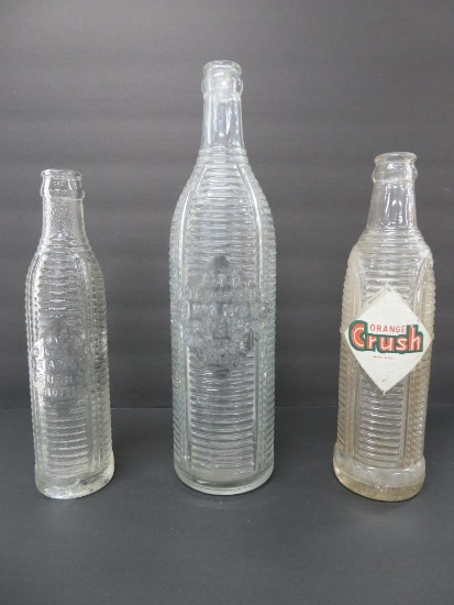 Three clear ribbed Orange Crush Bottles