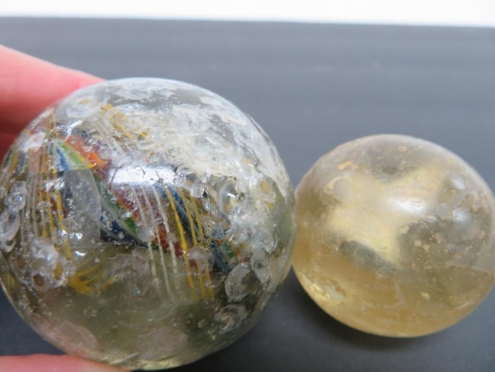 Two large handmade marbles, sulfide and latticino swirl