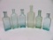 Six aqua medicine bottles, 5 1/2