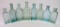 Eight aqua medicine bottles