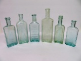 Six aqua medicine bottles, 5 1/2