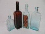 Four Medicine bottles, aqua, amber and with label