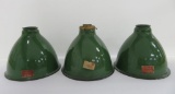 Three metal green and white enamel industrial shades