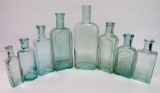 Eight aqua medicine bottles, 4