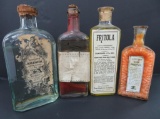 Four antique product bottles with contents, 5 3/4