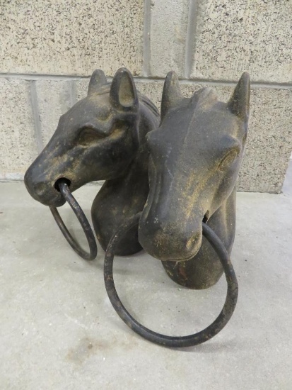 Two cast iron horse head hitching post tops