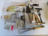 Assorted kitchen utensils, spoons, pizza cutter, spatulas, etc.